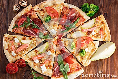 Selection of Assorted slices pizza on wooden background. Top view Stock Photo