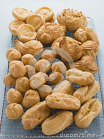 Selection of Choux Pastry Buns on a Cooling Rack Stock Photo