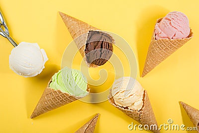 Selection of colorful ice cream scoops on yellow background Stock Photo