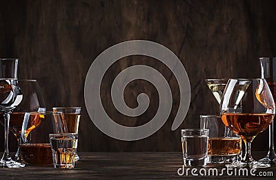 Selection of hard strong alcoholic drinks in big glasses and small shot glass in assortent: vodka, cognac, tequila, brandy and Stock Photo