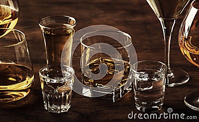 Selection of hard strong alcoholic drinks in big glasses and small shot glass in assortent: vodka, cognac, tequila, brandy and Stock Photo