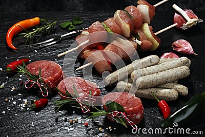 Selection of marinaded meat for bbq grilling with herbs on table Stock Photo