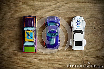 Selection of Mattel Hot Wheels toy model cars on a wooden floor Editorial Stock Photo