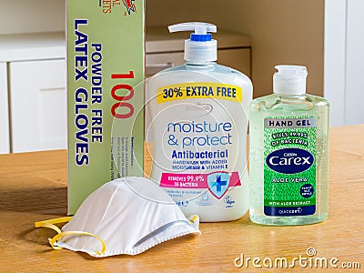 A selection of PPE for home & work use. Hand soap and gel, face mask and rubber gloves. Editorial Stock Photo