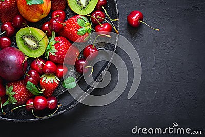 Selection of seasonal fruits and berries on a cast-iron dish. To Stock Photo