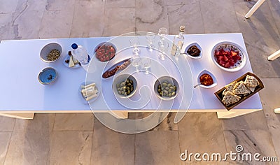 Selection of traditional greek aperitif, top view. olive,tomatoes,watermelon,pitas bread, cheese, ouzo Stock Photo