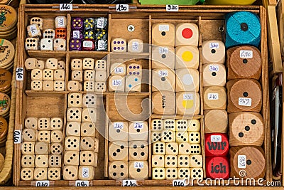 Selection of various handmade wooden dice for sale on a market s Editorial Stock Photo