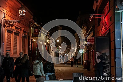 Selective blur on the Laze Teleckog street at night with blurred young people passing by Editorial Stock Photo