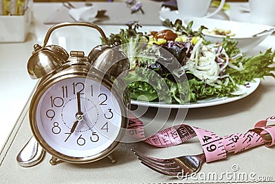 Alarm clock which a healthy food as the Healthy lifestyle Concept,Intermittent fasting image Stock Photo