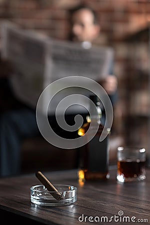 Selective focus of the ashtray with a cigar in it Stock Photo