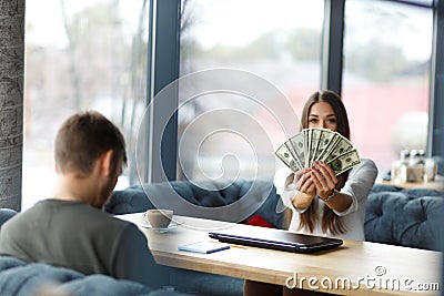 In selective focus of beautiful woman showing money . Restaurant meeting Stock Photo