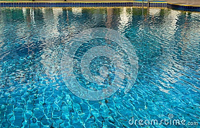 Selective focus on the blue surface of the water in the pool with reflections. Relaxing natural background Stock Photo