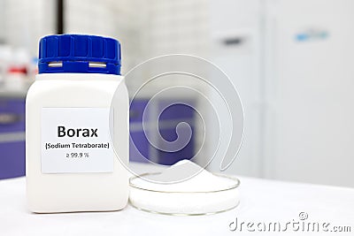 Selective focus of a bottle of borax chemical compound or sodium tetraborate beside a petri dish with solid powder substance Stock Photo