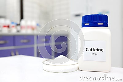 Selective focus of a bottle of pure caffeine chemical compound beside a petri dish with solid crystalline powder substance. Stock Photo