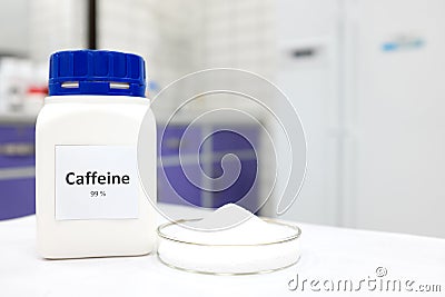 Selective focus of a bottle of pure caffeine chemical compound beside a petri dish with solid crystalline powder substance. Stock Photo