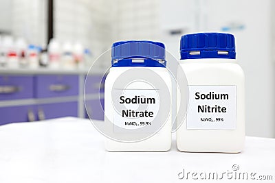 Selective focus of bottles of pure sodium nitrite and nitrate chemical compound preservative. White laboratory background. Stock Photo