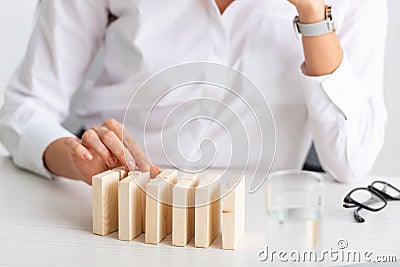 Selective focus of businesswoman stacking wooden Stock Photo