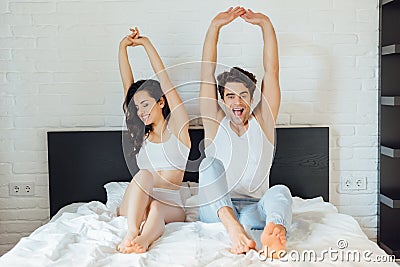 Selective focus of cheerful couple stretching Stock Photo