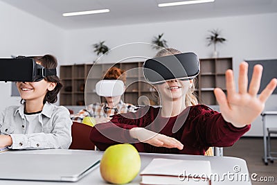 selective focus of cheerful schoolgirl in Stock Photo