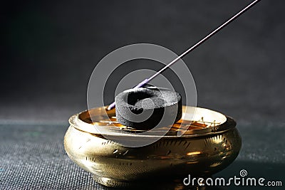 Selective focus closeup shot of an unlit incense on a black surface Stock Photo