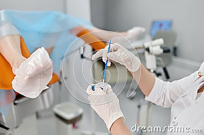 Selective focus closeup view on gynecologist hands taking biomaterial sample Stock Photo