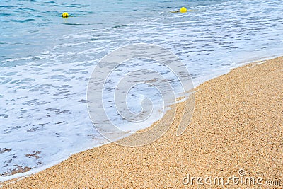 Selective focus. Crystal turquoise sea waves roll under the rays of the sun to the sandy beach. Close-up shot of soothing frothy Stock Photo