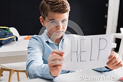 Selective focus of depressed schoolkid holding Stock Photo