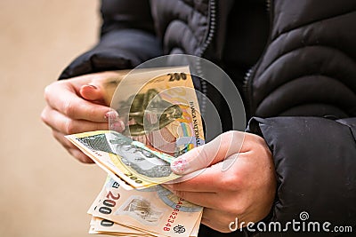 Selective focus on detail of LEI banknotes. Counting or giving Romanian LEI banknotes. World money concept, inflation and economy Stock Photo