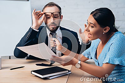 Focus of displeased client holding tie Stock Photo