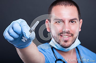 Selective focus of doctor wearing scrubs holding vaccine injection Stock Photo