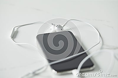 Selective focus of earphones connected to Stock Photo