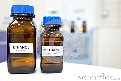 Selective focus of ethanol and methanol brown amber glass bottle inside a laboratory. Blurred background with copy space. Stock Photo