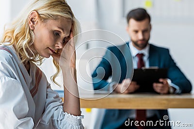 Focus of frustrated blonde employee near recruiter in suit Stock Photo