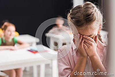Selective focus of frustrated schoolkid crying Stock Photo