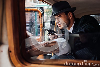 Selective focus of gangster sitting in Stock Photo