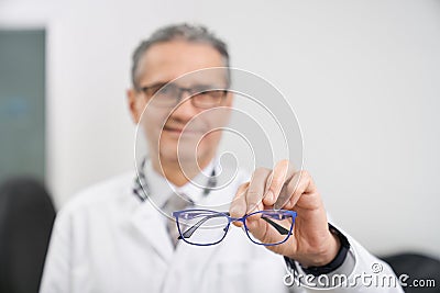 Selective focus of glasses in hands of oculist in clinic Stock Photo