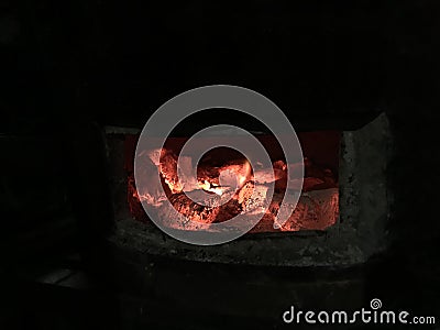 Selective focus on Glowing and flaming hot natural wood charcoal lump in street food BBQ grill stove background. Energy power heat Stock Photo