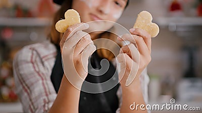 Selective focus of grandchild holding cookie dough with heart shape in hands Stock Photo