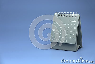 Selective focus of grey calendar show month of december on blue background with copy space Stock Photo