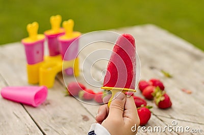 Selective focus of a hand holding homemade strawberry ice cream Stock Photo