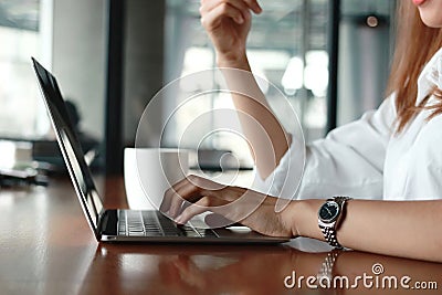 Selective focus on hands of business woman typing on keyboard of laptop. Lifestyle relaxed concept. Stock Photo