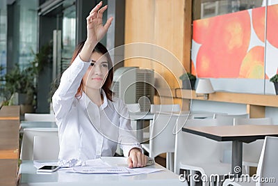 Selective focus on hands of frustrated Asian businesswoman throwing crumple paperwork in workplace. Stressed business concept Stock Photo