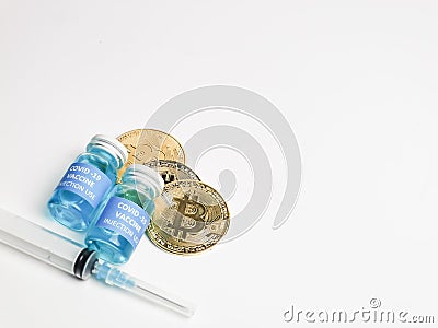 Selective focus image Corona virus vaccines with syringe and bitcoin isolated on white background. Stock Photo