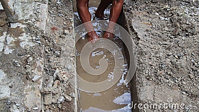 Selective focus image, workers clearing sewers from clogged trash Editorial Stock Photo