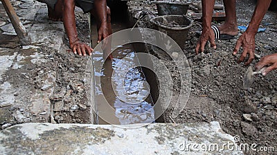 Selective focus image, workers clearing sewers from clogged trash Editorial Stock Photo