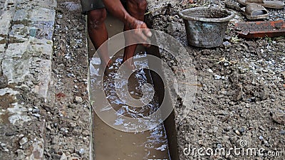 Selective focus image, workers clearing sewers from clogged trash Editorial Stock Photo