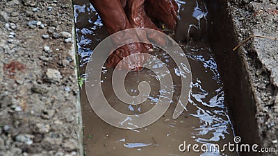 Selective focus image, workers clearing sewers from clogged trash Editorial Stock Photo