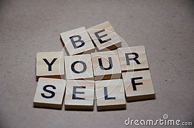 Selective focus on Inscription Be Yourself outlined on beige background with copy space. Motivational card with phrase be yourself Stock Photo