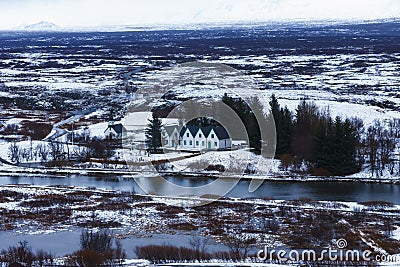 Selective focus - Landscape in Iceland with houses, mountains, rivers, trees and snow Stock Photo