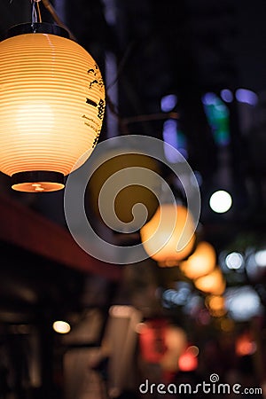 Selective Focus. Lantern hangging overhead in Omoide Yokocho in Shinjuku. Portrait Orientation Editorial Stock Photo